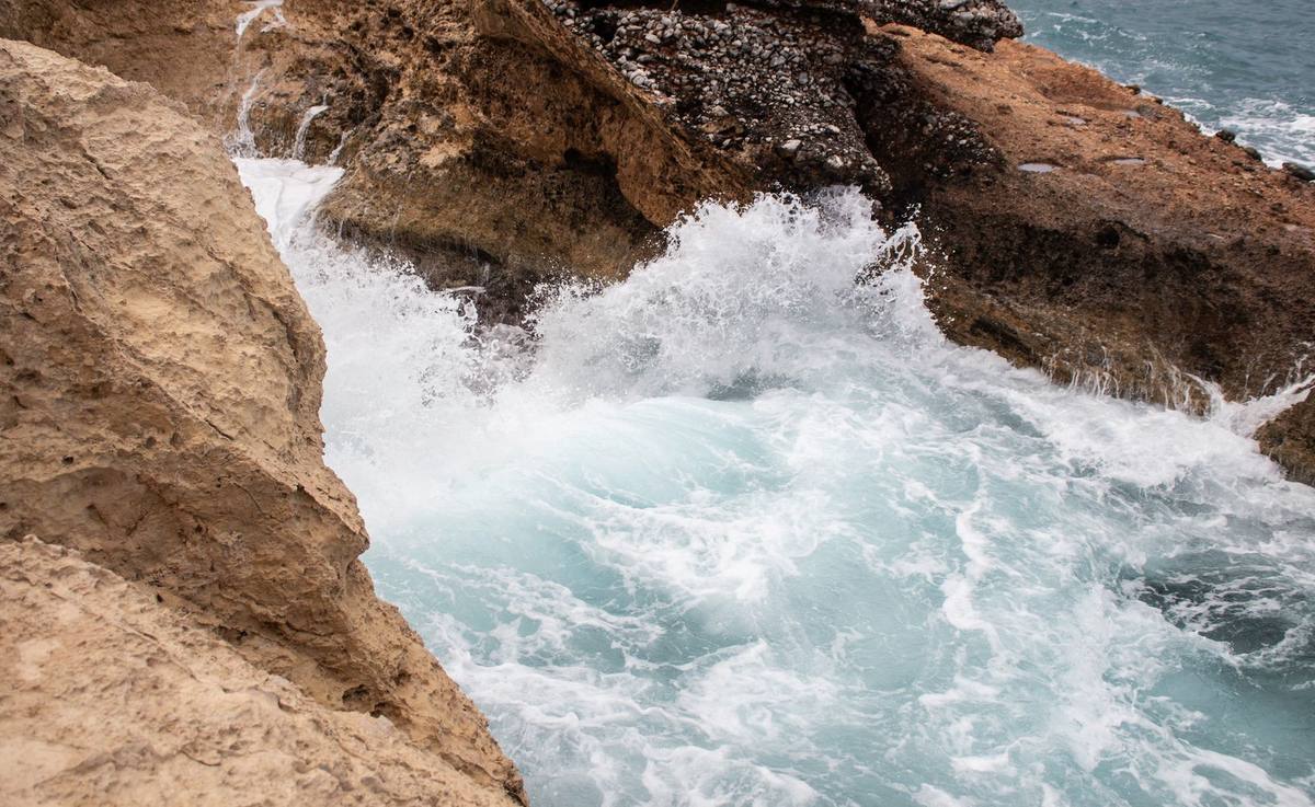 Waves breaking against a rugged rocky shore