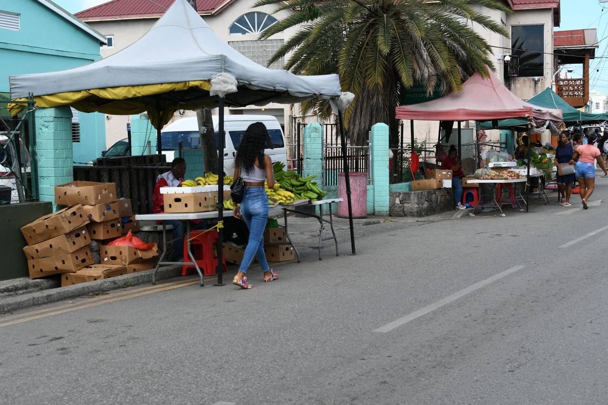 A busy outdoor produce market in the Caribbean