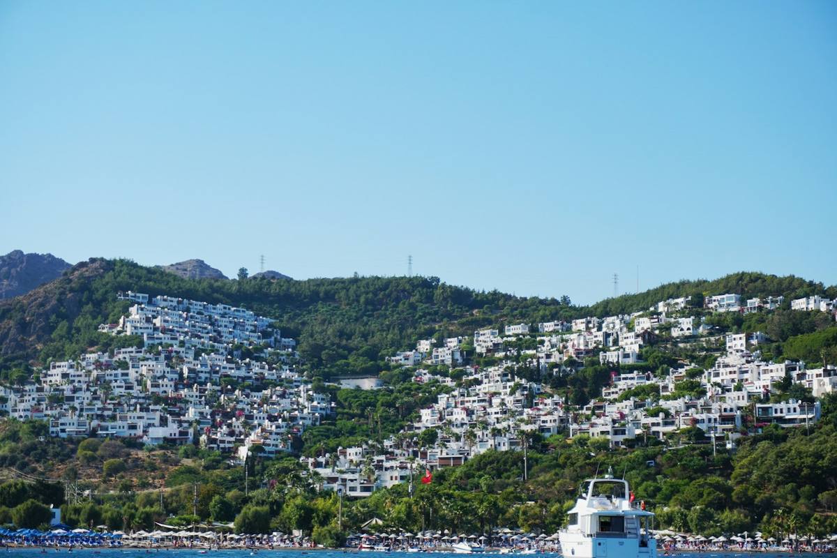 White Bodrum houses set among green hillsides above the bay