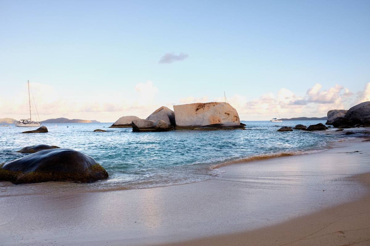 Rocks and sand on a quiet beach at sunset