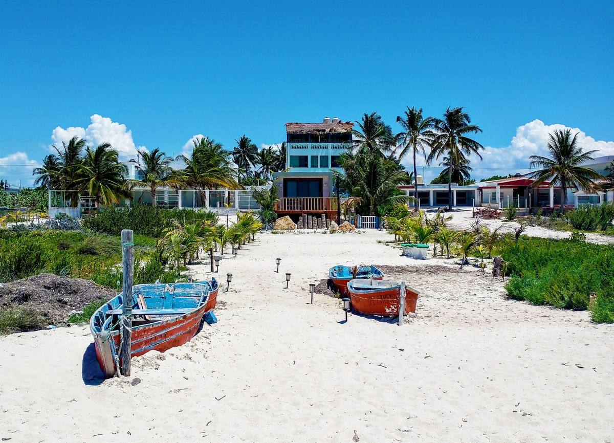 Boats and coconut palms on a beach in Mexico's Yucatán