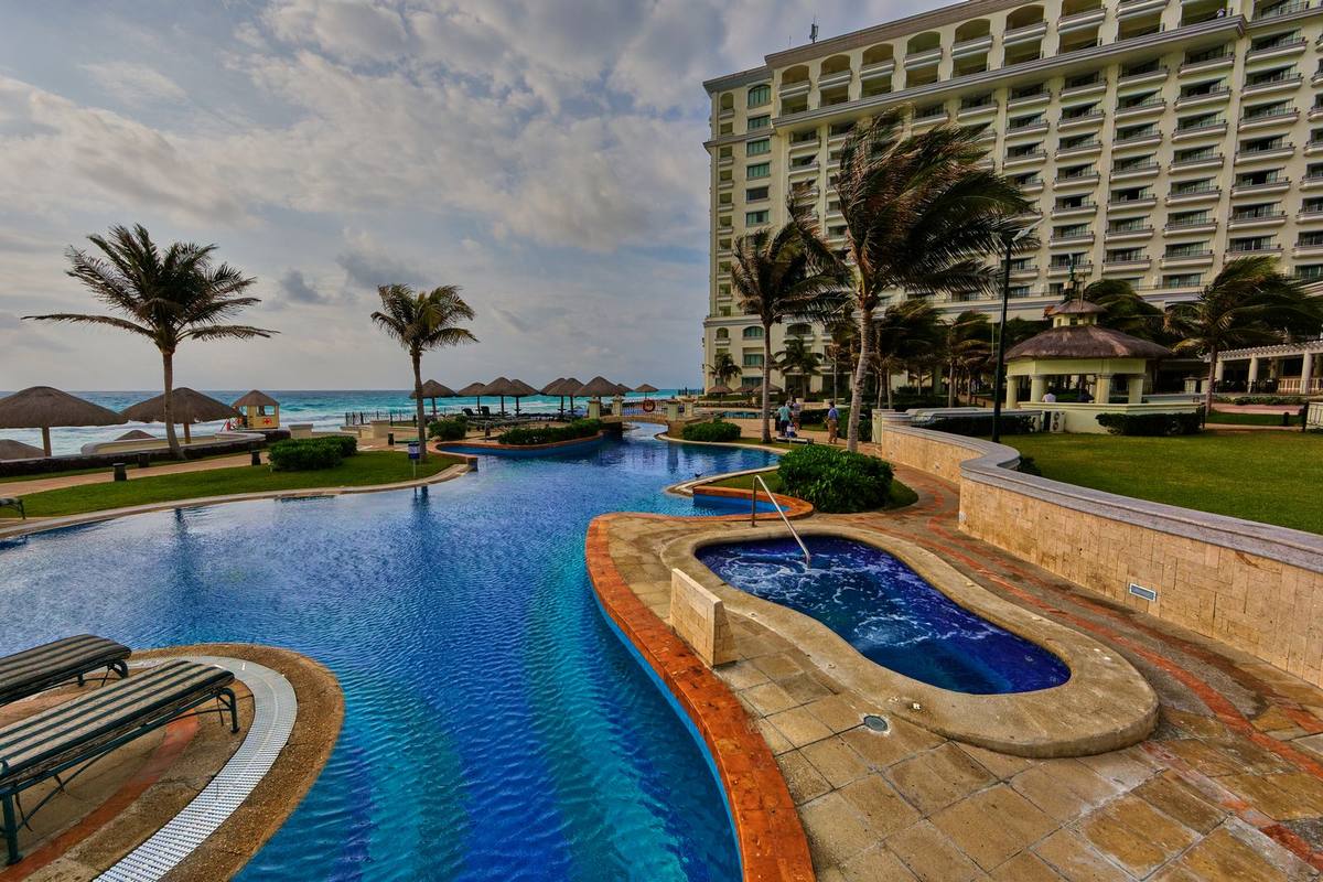 A resort pool overlooking the sea in Cancún, Mexico