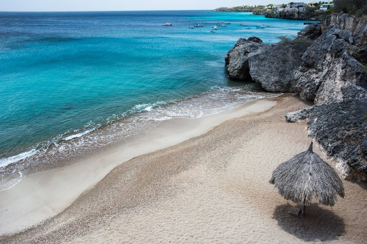 A quiet beach cove framed by rocky cliffs