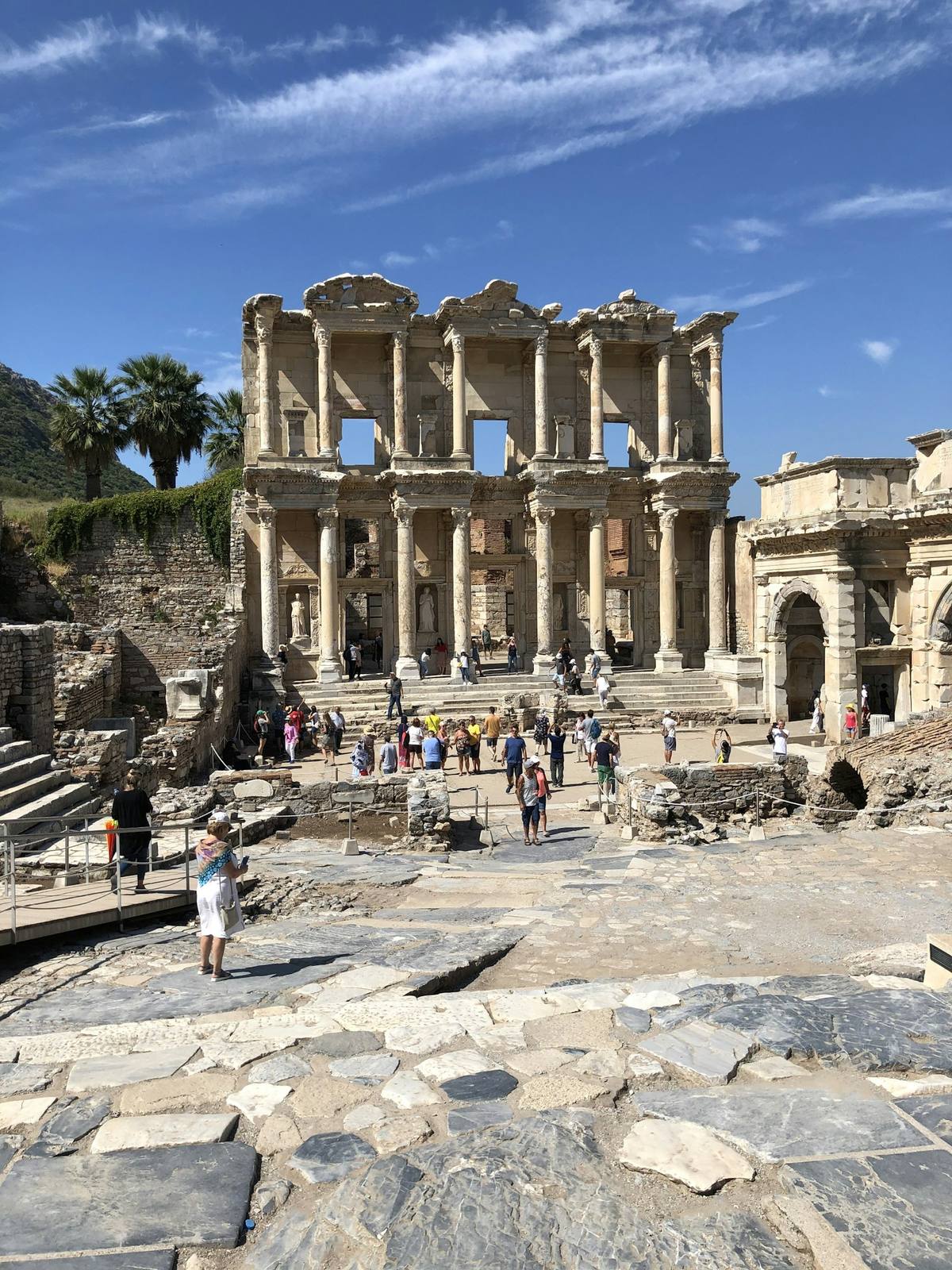 Visitors on the marble walkway to the Library of Celsus